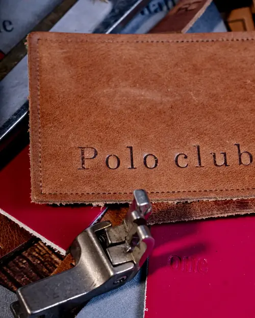 Leather label beside the presser foot of a sewing machine
